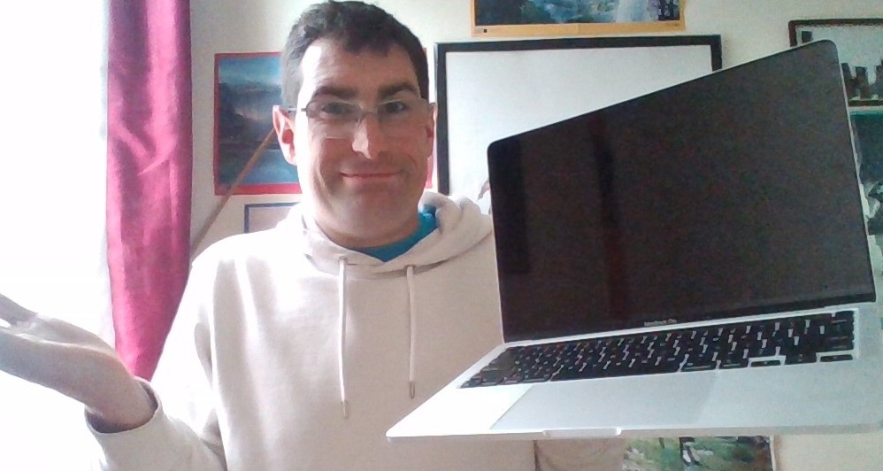 Kris, the Tech Restorer, shrugging off that the MacBook Pro is still faulty